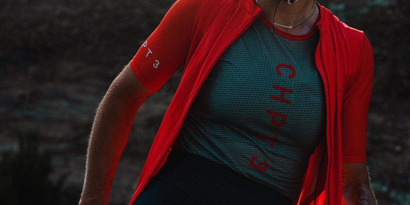 Female cyclist wears CHPT3 Red jersey and Green Base Layer